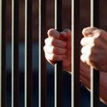 prisoner-behind-bars