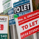 Estate agents signs outside property to let in England.